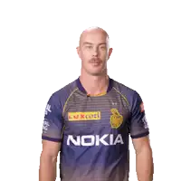a man wearing a nokia shirt is pointing to his head