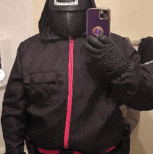 a person taking a picture with a cell phone