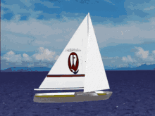 a sailboat with the letter q on the sail is in the ocean