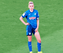 a female soccer player wearing a blue shirt with synco on it