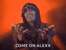 a man with dreadlocks is making a funny face and says `` come on alexx '' .