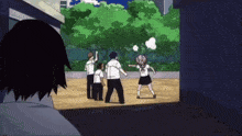 a group of people are playing a game of volleyball in a courtyard .