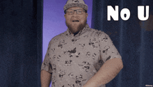 a man wearing glasses and a hat says " no u " in white letters