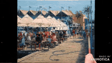 a painting of people sitting under umbrellas is being made in animotica