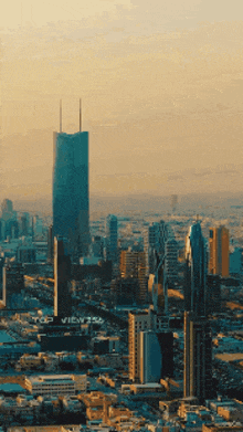 an aerial view of a city with a tall building that says top views