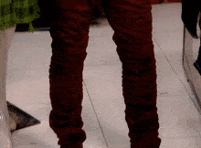 a close up of a person 's legs with red pants