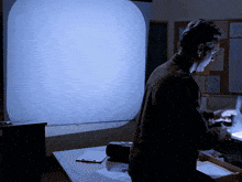 a man stands in front of a white board with a circle on it that says ' a ' on it