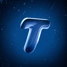 the letter t is made of glass on a dark blue background
