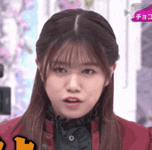 a close up of a girl 's face with a box of chocolate behind her