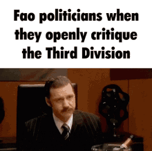 a man in a suit and tie sits in front of a sign that says fao politicians when they openly critique the third