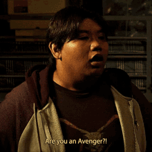 a man in a hoodie says " are you an avenger ? "