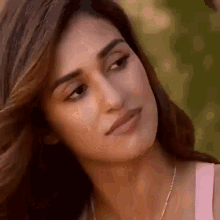 a close up of a woman 's face with her eyes closed .