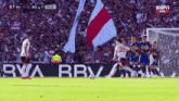 a soccer game is being played in front of a bbva banner