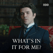 a man in a suit sits in a chair with the words what 's in it for me below him