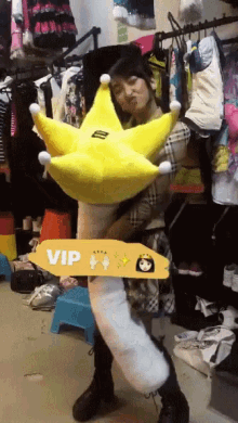 a woman is holding a stuffed animal and a sign that says vip