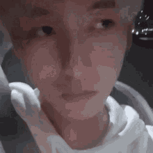 a close up of a person 's face in a car with a blurred background .