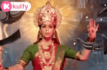 a woman is dressed as a goddess and is holding a sword in her hands .