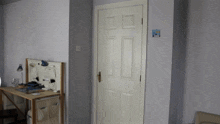 a white door in a room with a sticker on the wall that says ' a '
