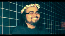 a man wearing glasses and a flower crown on his head