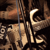 a person playing a guitar in front of a sign that says " no "