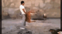 a man in a white shirt is standing next to a dog in a painting .