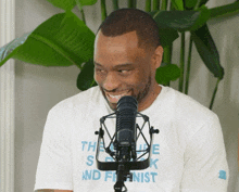 a man wearing a t-shirt that says the speak and feminist