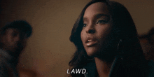 a woman is talking to a man in a dark room and says lawd .