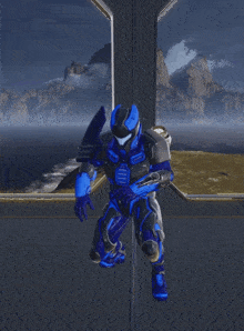 a blue and black armored soldier stands in front of a mountain range
