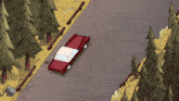 a red car is driving down a road in the woods
