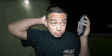 a man wearing a black shirt that says ' miss tori ' on it