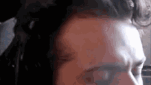 a close up of a man 's face with his eyes closed