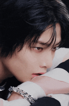 a close up of a man 's face with his hand on his face