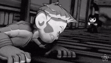 a black and white cartoon of a boy laying on the floor next to a bunny .