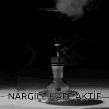 a hookah with smoke coming out of it and the words " nargile kafe aktif " on the bottom