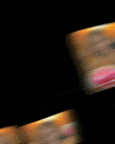 a blurred image of a woman 's face is displayed on a black background
