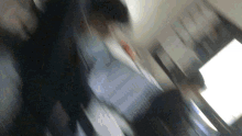 a blurry picture of a person walking down a escalator