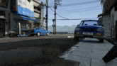 a blue car is parked on the side of the road in front of a building with a sign on it that says ' a '