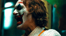 a close up of a person wearing a clown costume .