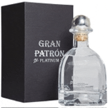a bottle of tequila is next to a box that says gran patron platinum