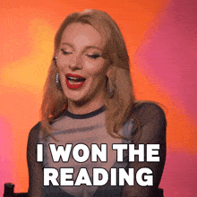 a woman says " i won the reading " with her mouth wide open