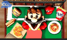 a mario video game character is laying on a bed surrounded by food and a bag of fud chips