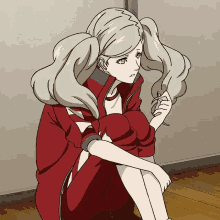 a girl with pigtails is sitting on the floor