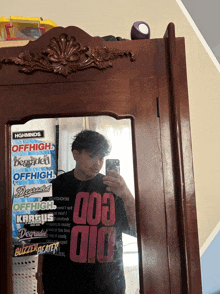 a man is taking a selfie in front of a mirror with stickers on it that say offhigh