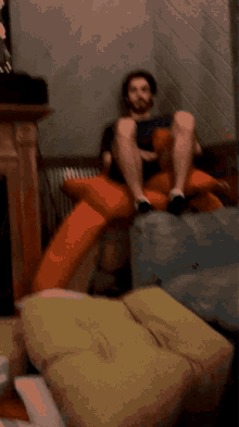 a man is sitting on a couch with his legs up