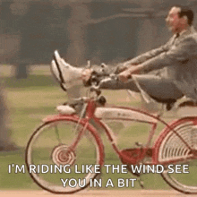 a man in a suit is riding a bicycle with his feet up and a quote .