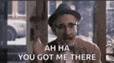 a man in a hat and bow tie is giving a middle finger and saying `` ah ha you got me there '' .