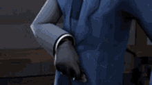 a man in a suit and tie is pointing at something with his finger .