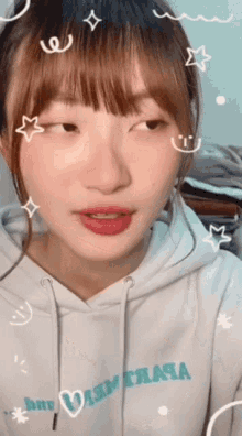 a girl wearing a white hoodie that says ' warm ' on it