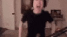 a blurry picture of a person standing in a living room .