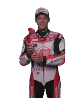a motorcycle racer wearing a red bull hat is holding a trophy
